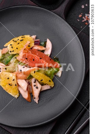 Delicious fresh juicy salad of sliced chicken, grapefruit, lettuce, sesame with olive oil Delicious fresh juicy salad of sliced chicken, grapefruit, lettuce, sesame with olive oil 107903633