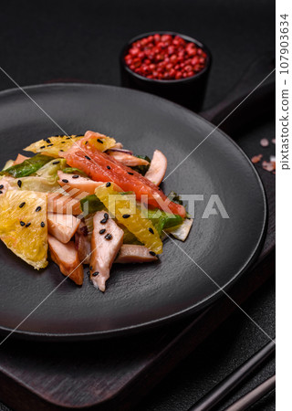 Delicious fresh juicy salad of sliced chicken, grapefruit, lettuce, sesame with olive oil Delicious fresh juicy salad of sliced chicken, grapefruit, lettuce, sesame with olive oil 107903634