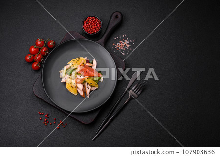 Delicious fresh juicy salad of sliced chicken, grapefruit, lettuce, sesame with olive oil Delicious fresh juicy salad of sliced chicken, grapefruit, lettuce, sesame with olive oil 107903636
