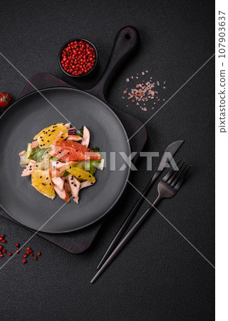 Delicious fresh juicy salad of sliced chicken, grapefruit, lettuce, sesame with olive oil Delicious fresh juicy salad of sliced chicken, grapefruit, lettuce, sesame with olive oil 107903637
