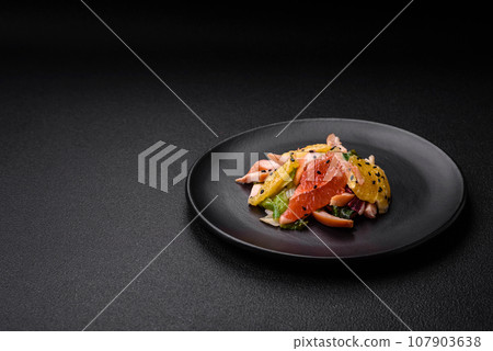 Delicious fresh juicy salad of sliced chicken, grapefruit, lettuce, sesame with olive oil 107903638