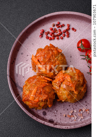 Delicious fresh meatballs from minced meat or fish with tomato sauce 107903671