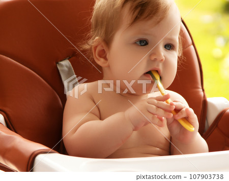 Closeup portrait of charming hungry little female 107903738