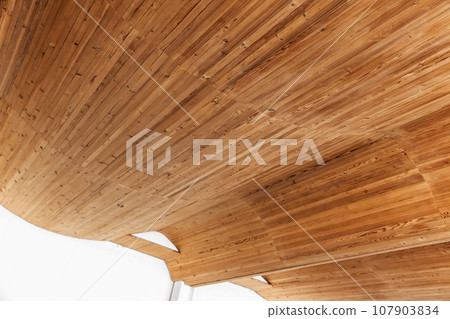 Empty interior with bent ceiling made of wooden planks, parametric architecture 107903834