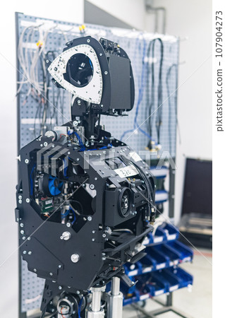 humanoid robot in the process of assembly and adjustment in the workshop 107904273