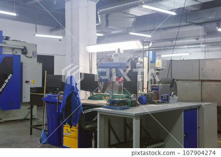 industrial workshop with machine tools in blue colors 107904274