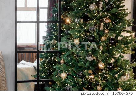 Designer Christmas tree decoration with lights. The concept of celebrating New Year and Christmas. Designer Christmas tree decoration with lights. The concept of celebrating New Year and Christmas. 107904579
