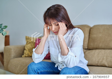 Middle-aged woman experiencing stress, difficulties, headache 107904937
