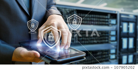 A man works on a secure tablet computer. 107905202