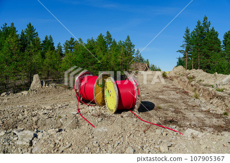 Laying High-Voltage Cables Underground Through the Forest to Connect Wind Turbines to the Power Grid Laying High-Voltage Cables Underground Through the Forest to Connect Wind Turbines to the Power Grid 107905367