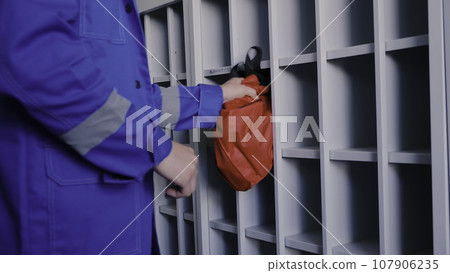 Medicine worker in blue uniform putting red bag in spare place. Clip. Emergency worker in uniform. Medicine worker in blue uniform putting red bag in spare place. Clip. Emergency worker in uniform. 107906235