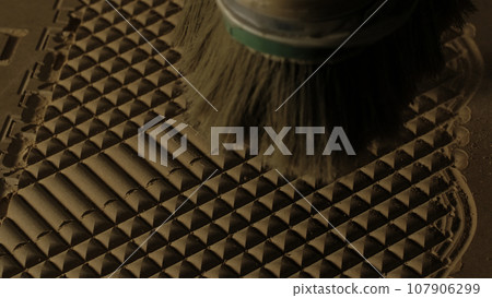 Close up of blowing away the dust from a wooden carved board with air flow. Creative. Industrial background, concept of carpentry. Close up of blowing away the dust from a wooden carved board with air flow. Creative. Industrial background, concept of carpentry. 107906299