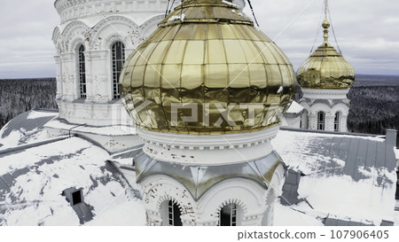 Facade of the orthodox church with golden domes. Clip. Concept of religion and architecture. Facade of the orthodox church with golden domes. Clip. Concept of religion and architecture. 107906405
