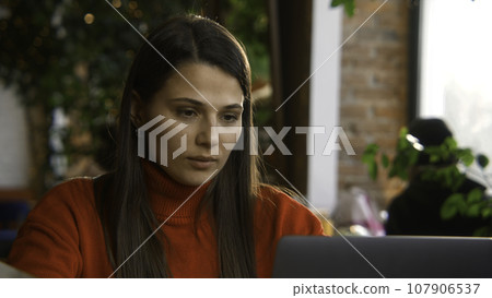 Close-up of woman typing on laptop. Stock footage. Beautiful young woman is typing novel on laptop in cafe. Young writer is writing novel on laptop Close-up of woman typing on laptop. Stock footage. Beautiful young woman is typing novel on laptop in cafe. Young writer is writing novel on laptop 107906537