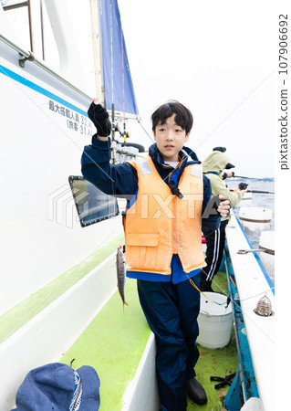 boy enjoying sea fishing 107906692