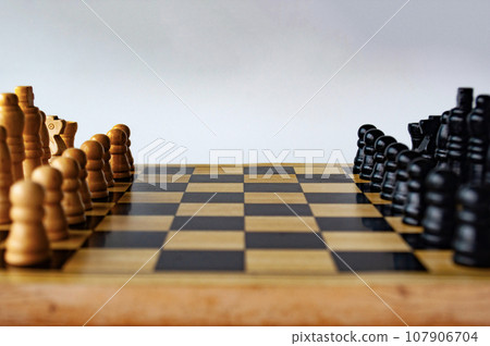 Battle between white and black chess on a chess boar. Strategy and tactics concept. 107906704