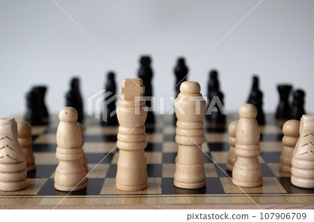 Battle between white and black chess on a chess boar. Strategy and tactics concept 107906709