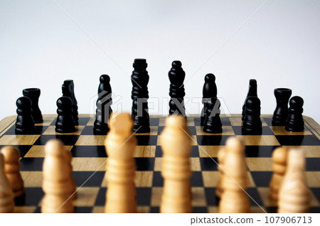 Battle between white and black chess on a chess boar. Strategy and tactics concept 107906713