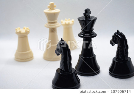 Chess game. Battle between black and white chess with white background. Strategy and battle concept 107906714