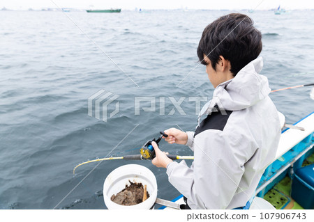 boy enjoying sea fishing 107906743