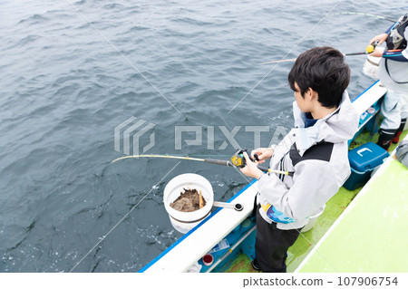 boy enjoying sea fishing 107906754
