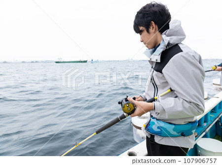 boy enjoying sea fishing 107906757