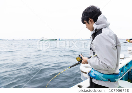 boy enjoying sea fishing 107906758