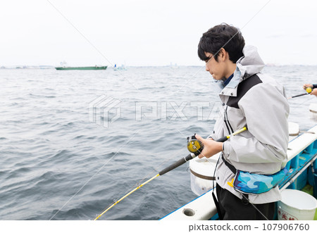 boy enjoying sea fishing 107906760