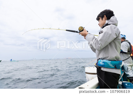 A man enjoying sea fishing 107906819