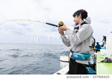 A man enjoying sea fishing 107906820