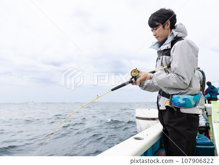 A man enjoying sea fishing 107906822