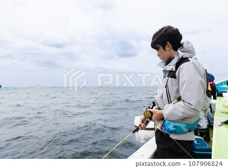 A man enjoying sea fishing 107906824