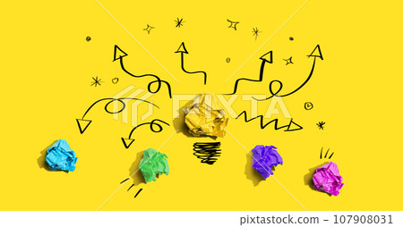 Brainstorming concept with a crumpled paper light bulb Brainstorming concept with a crumpled paper light bulb 107908031