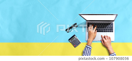 Person using a laptop computer Person using a laptop computer 107908036