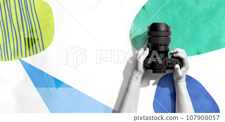 Person holding a SLR camera Person holding a SLR camera 107908057