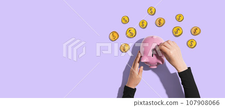 Person depositing money in a piggy bank Person depositing money in a piggy bank 107908066