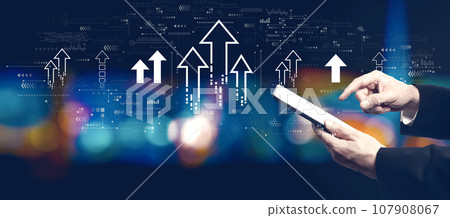 Rising arrow theme with businessman using a tablet computer 107908067