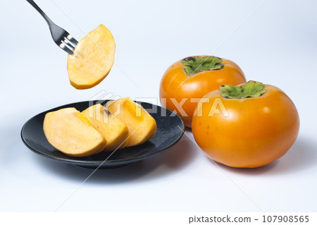 Photo of cut persimmons on a white background Tottori prefecture Kiutaro persimmons 107908565