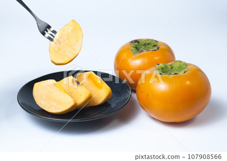Photo of cut persimmons on a white background Tottori prefecture Kiutaro persimmons 107908566