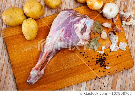 Raw lamb leg with natural ingredients before cooking 107908763