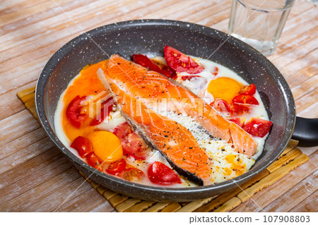 Fried eggs with salmon and cherry tomato Fried eggs with salmon and cherry tomato 107908803