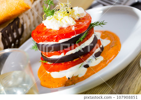 Grilled eggplant and tomatoes stack with spicy sauce Grilled eggplant and tomatoes stack with spicy sauce 107908851