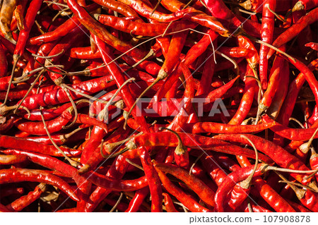 Red spicy chili peppers at asian market close up texture background Red spicy chili peppers at asian market close up texture background 107908878