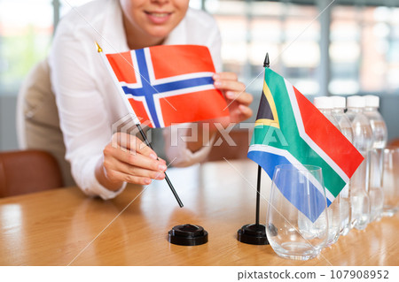 Blurry girl set midget flags of South Africa and Norway before international negotiations Blurry girl set midget flags of South Africa and Norway before international negotiations 107908952