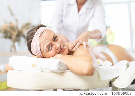 Close-up of young woman getting back and shoulder massage Close-up of young woman getting back and shoulder massage 107909095