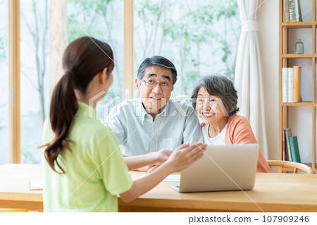 Senior couple listening to care manager Senior couple listening to care manager 107909246