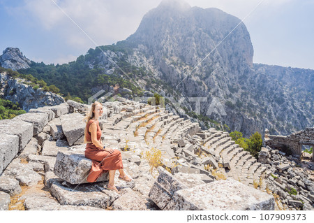 Woman tourist explores Stunning Ancient Theater of Termessos Ancient City turkiye, GO Everywhere Woman tourist explores Stunning Ancient Theater of Termessos Ancient City turkiye, GO Everywhere 107909373