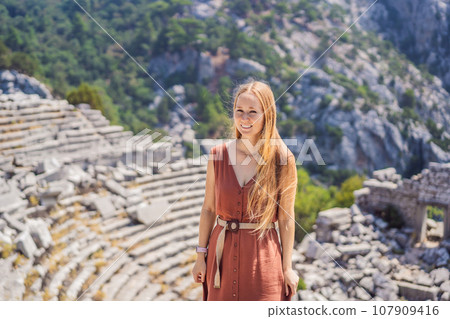 Woman tourist explores Stunning Ancient Theater of Termessos Ancient City turkiye, GO Everywhere 107909416