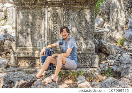Man tourist explores Stunning Ancient Theater of Termessos Ancient City turkiye, GO Everywhere 107909435