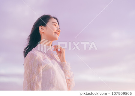 Woman portrait with sunset background 107909866